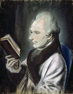 Pastel colour portrait of a man seated in profile, wearing a jacket with a brown fur collar and reading a book