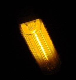 Photo of a a rectangular bulb creating very yellow light against a very black background