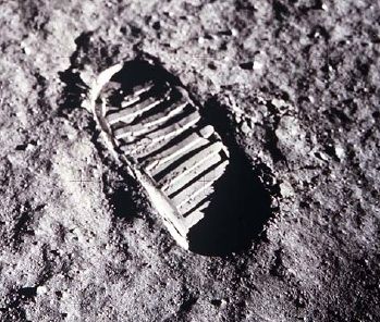 Photographie noir et blanc d'une empreinte de pas sur le sol lunaire