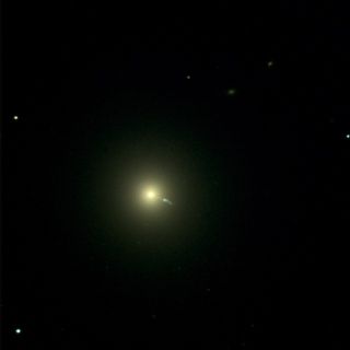Luminous yellow dot surrounded by a halo and other small luminous dots against a very black background